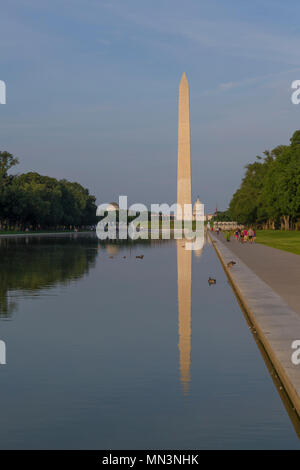 Visitors stroll on summer evening, Washington Monument on the Reflecting Pool, Washington DC, USA, North America Stock Photo