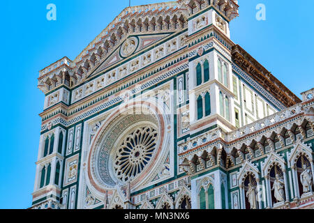 Facade of the Cattedrale di Santa Maria del Fiore (Cathedral of Saint Mary of the Flower) in Florence, Italy against a cloudless sky