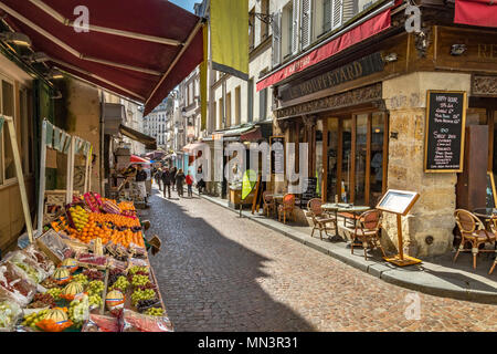 A fruit stall with fruit and vegetables with Le Mouffetard , a restaurant  on Rue Mouffetard, Paris, France Stock Photo