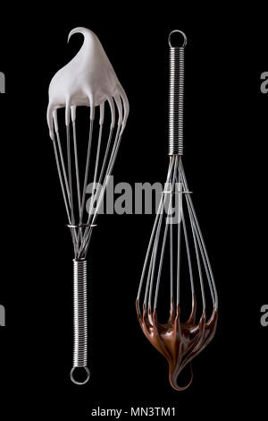 Whisk with meringue cream and melted chocolate Isolated on white background Stock Photo