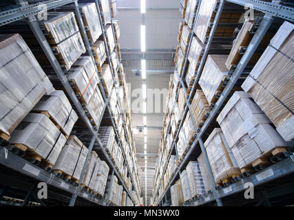Rows of shelves with boxes in warehouse Stock Photo