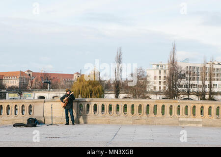 Berlin, Germany 15 February 2018: street musician or guitarist. Man sings and plays guitar on street in historic center. Stock Photo