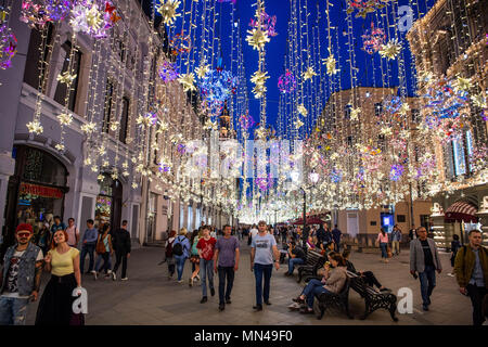 14 May 2018, Russia, Moscow: Visitors strolling in a shopping street next to Red Square. Light chains were hung for decoration. Photo: Christophe Gateau/dpa Stock Photo