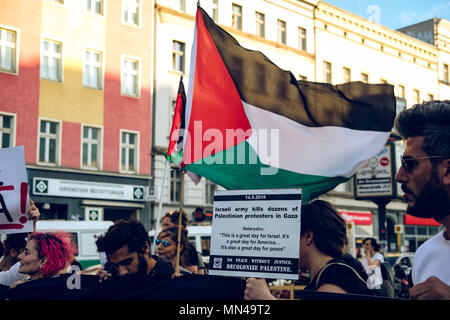 Berlin, Germany. 14th may 2018. Banner and Palestine flag seen at the protest in Berlin in support of Palestine. Hundreds of demonstrators gathering in Berlin to protest the violent actions that has been taken by the Israeli military in Gaza which has led to at least 50 dead. Credit: SOPA Images Limited/Alamy Live News Stock Photo