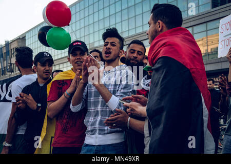 Berlin, Germany. 14th May, 2018. Young men sing at the protest in Berlin against Israel actions in Gaza.Hundreds of demonstrators gathering in Berlin to protest the violent actions that has been taken by the Israeli military in Gaza which has led to at least 50 dead. Credit: Lorena De La Cuesta/SOPA Images/ZUMA Wire/Alamy Live News Stock Photo