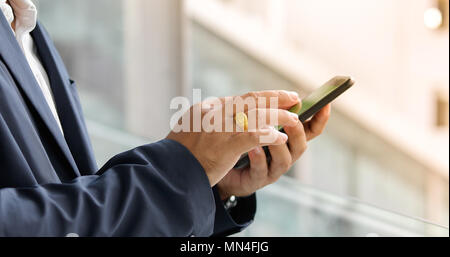Businessman asian using phone for celling and texting on her mobile phone Stock Photo