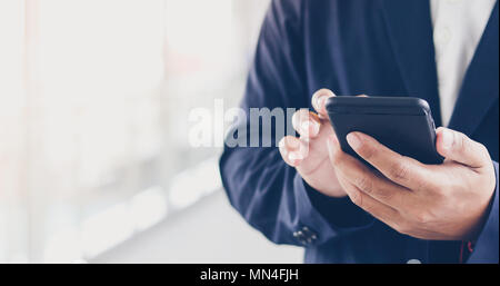 Businessman asian using phone for celling and texting on her mobile phone Stock Photo
