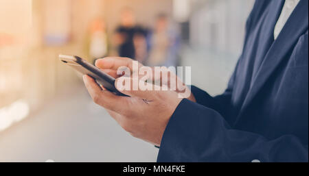 Businessman asian using phone for celling and texting on her mobile phone Stock Photo