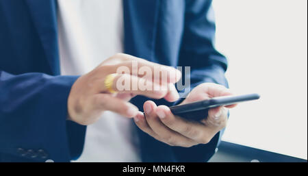 Businessman asian using phone for celling and texting on her mobile phone Stock Photo