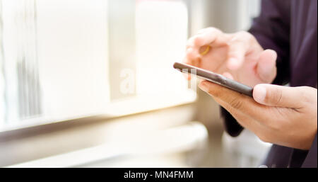 Businessman asian using phone for celling and texting on her mobile phone Stock Photo