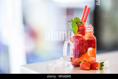 Strawberry non alcoholic lemonade with basil and ice cubes. Stock Photo