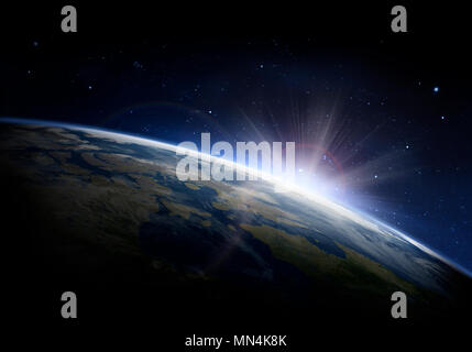 Sunlight ascending over Earth in outer space Stock Photo