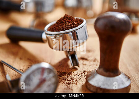 Espresso grounds and coffee tamper Stock Photo
