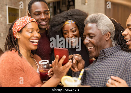 Happy multi-generation family using smart phone Stock Photo