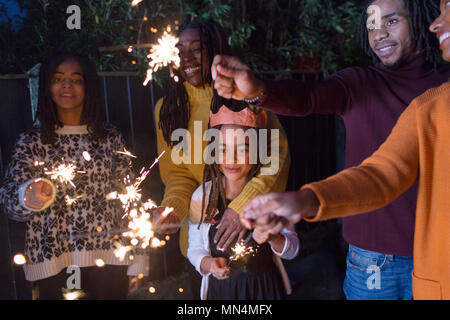 Family celebrating with sparklers Stock Photo