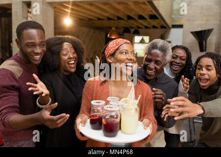 Happy multi-generation family enjoying lemonade and sangria on patio Stock Photo