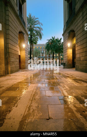 Narrow street entrance to illuminated Plaza Real in in Gothic quarter of Barcelona, Catalonia, Spain Stock Photo