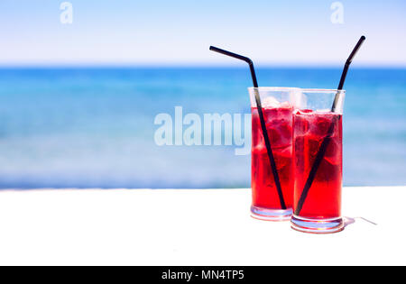 Two cocktail glasses on sea background Stock Photo