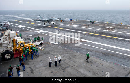 180508-N-JU894-0015 ATLANTIC OCEAN (May 8, 2018) Sailors from the French navy watch an E/A-18G Growler from Electronic Attack Squadron (VAQ) 131 land on the flight deck aboard the aircraft carrier USS George H.W. Bush (CVN 77). Bush is underway in the Atlantic Ocean conducting carrier air wing exercises with the French navy to strengthen partnerships and deepen interoperability between the two nations' naval forces. (U.S. Navy photo by Mass Communication Specialist 3rd Class Brooke Macchietto) Stock Photo