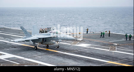 180508-N-JU894-0029 ATLANTIC OCEAN (May 8, 2018) Sailors from the French navy photograph an E/A-18G Growler from Electronic Attack Squadron (VAQ) 131 preform a touch and go on the flight deck aboard the aircraft carrier USS George H.W. Bush (CVN 77). Bush is underway in the Atlantic Ocean conducting carrier air wing exercises with the French navy to strengthen partnerships and deepen interoperability between the two nations' naval forces. (U.S. Navy photo by Mass Communication Specialist 3rd Class Brooke Macchietto) Stock Photo