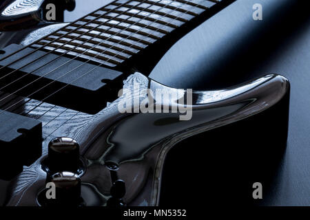 Black electric guitar detail close-up on black background Stock Photo