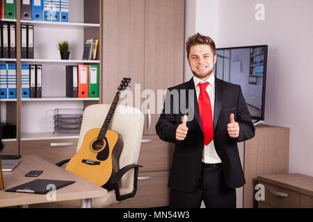 Successful businessperson showing thumbs up to the camera Stock Photo