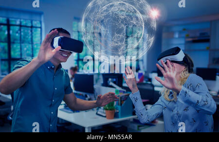 Computer programmers testing virtual reality simulator glasses, viewing futuristic hologram Stock Photo