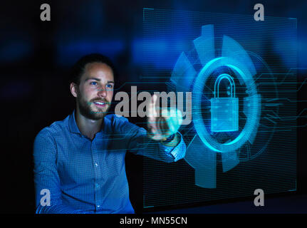 Businessman accessing security feature on futuristic hologram computer Stock Photo