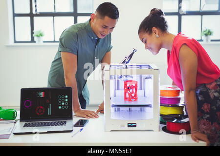 Designers watching 3D printer Stock Photo