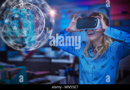 Enthusiastic female computer programmer testing virtual reality simulator glasses, viewing futuristic hologram Stock Photo