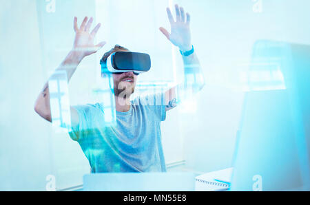 Male computer programmer testing virtual reality simulator glasses in office Stock Photo