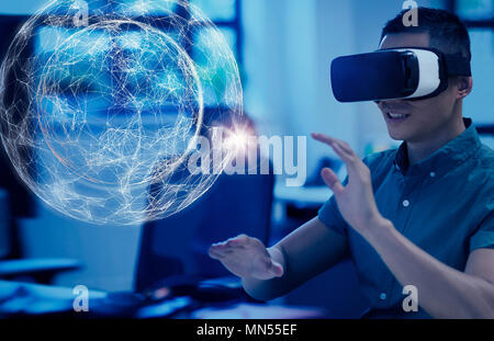 Computer programmer testing virtual reality simulator glasses, viewing projection hologram Stock Photo