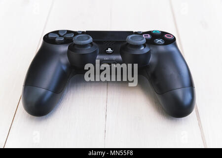 LONDON - MAY 03, 2018: Video games PlayStation gaming controller on wood background Stock Photo