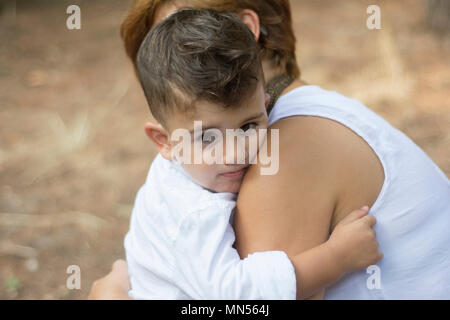 Little boy hugging his mother Stock Photo