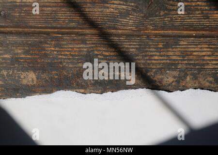 Torn White Paper on Dark Wood Background with shaft of light Stock Photo