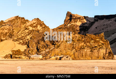 South Iceland. Drangurinn rock, in Drangshlíð below Eyjafjöll. In Icelandic legend it is the home of elves and was placed here by Grettir the Strong Stock Photo