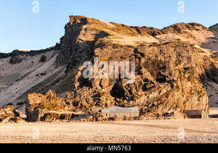 South Iceland. Drangurinn rock, in Drangshlíð below Eyjafjöll. In Icelandic legend it is the home of elves and was placed here by Grettir the Strong Stock Photo