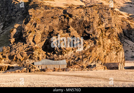 South Iceland. Drangurinn rock, in Drangshlíð below Eyjafjöll. In Icelandic legend it is the home of elves and was placed here by Grettir the Strong Stock Photo