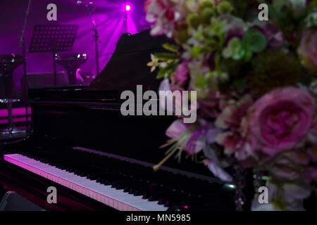Stage with magenta lights and microphones ready for concert Stock Photo