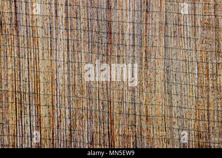 Mat of brown bamboo wire together to create a fence, Plana mountain, Bulgaria Stock Photo