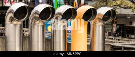 Five shiny stainless steel ventilation pipes atop the Pre-Columbian Gold Museum in San Jose, Costa Rica. Stock Photo