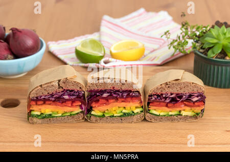 Rainbow salad sandwiches with homemade buckwheat bread, displayed on a wooden board. This fresh healthy lunch is low calorie, dairy free & gluten free. Stock Photo