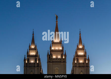 Angel Moroni and spires of Salt Lake Temple lit up at sunset. Church of Jesus Christ of Latter-day Saints, Temple Square, Salt Lake City, Utah, USA. Stock Photo