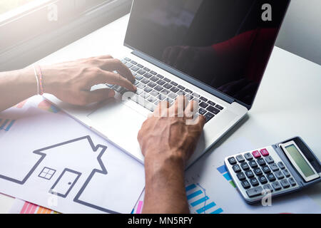 Business, architecture, building, construction concept - close up of architect working on laptop . Stock Photo