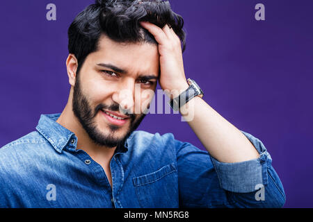 Portrait of eastern arabian man on purple background Stock Photo