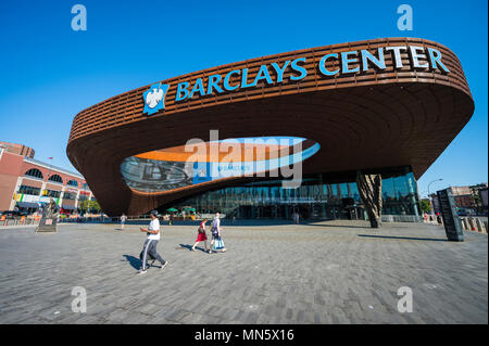 NEW YORK CITY - AUGUST 30, 2016: Pedestrians pass under the distinctive architecture of the Barclays Center, a  sports and entertainment arena Stock Photo