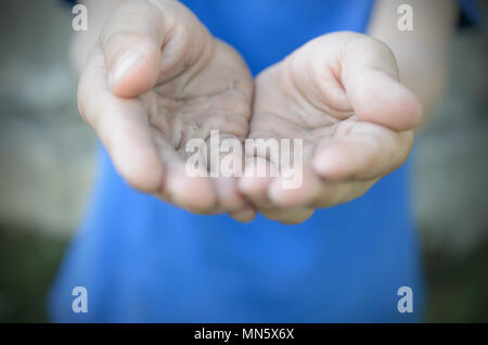 Asking dirty palms, folded in the shape of a boat. Poverty Stock Photo