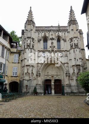 Front facade of the Basilica Saint-Pierre Avignon, France and an almost empty cobblestone courtyard. Stock Photo