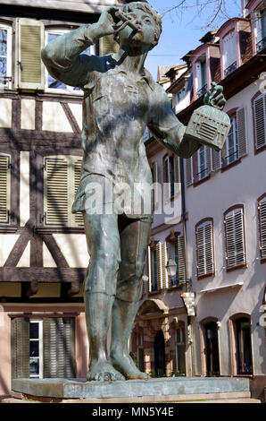 Statue of a young boy, a bird catcher with his flute and small birdcage, given to the city during an exchange of sculpture with the city of Munich Stock Photo