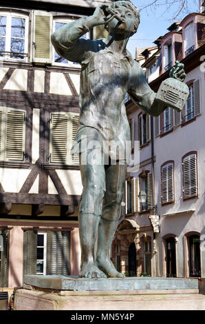 Statue of a young boy, a bird catcher with his flute and small birdcage, given to the city during an exchange of sculpture with the city of Munich Stock Photo